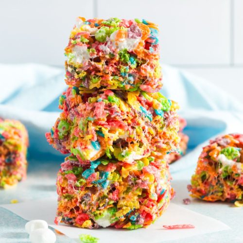 three squares of colorful fruity pebbles squares stacked on eachother