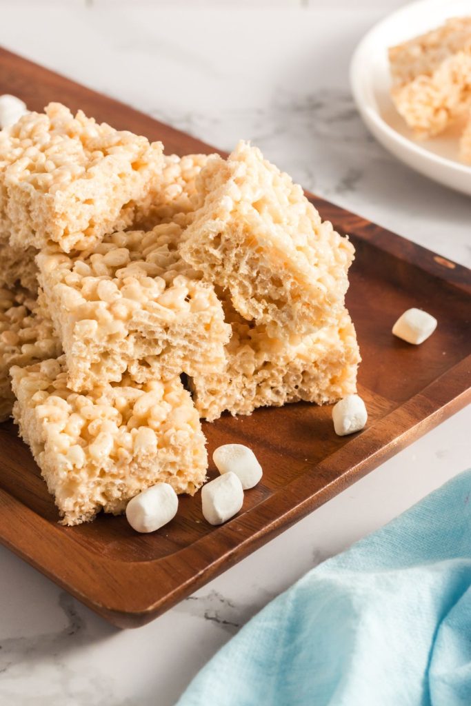 a brown tray with squares of rice krispie treats