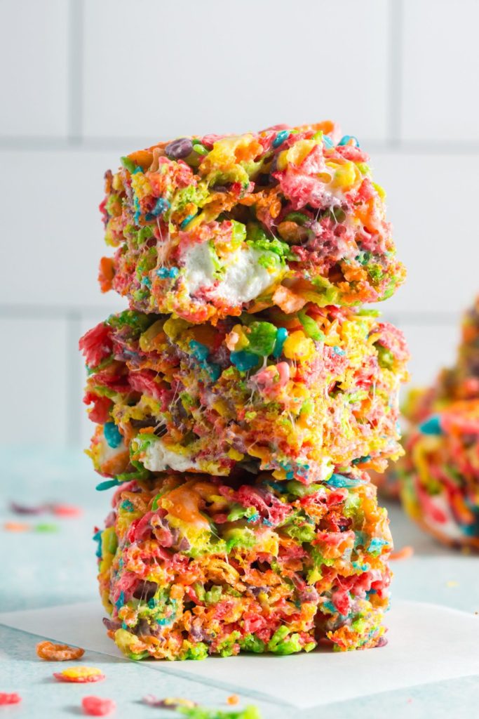 Three squares of rainbow colored rice krispie treats stacked on each other